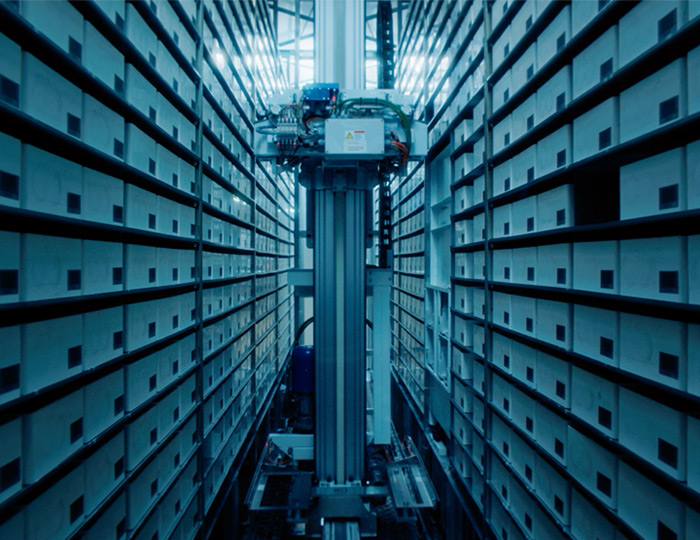 Image of an automated pharmacy robot arm extracting medication.