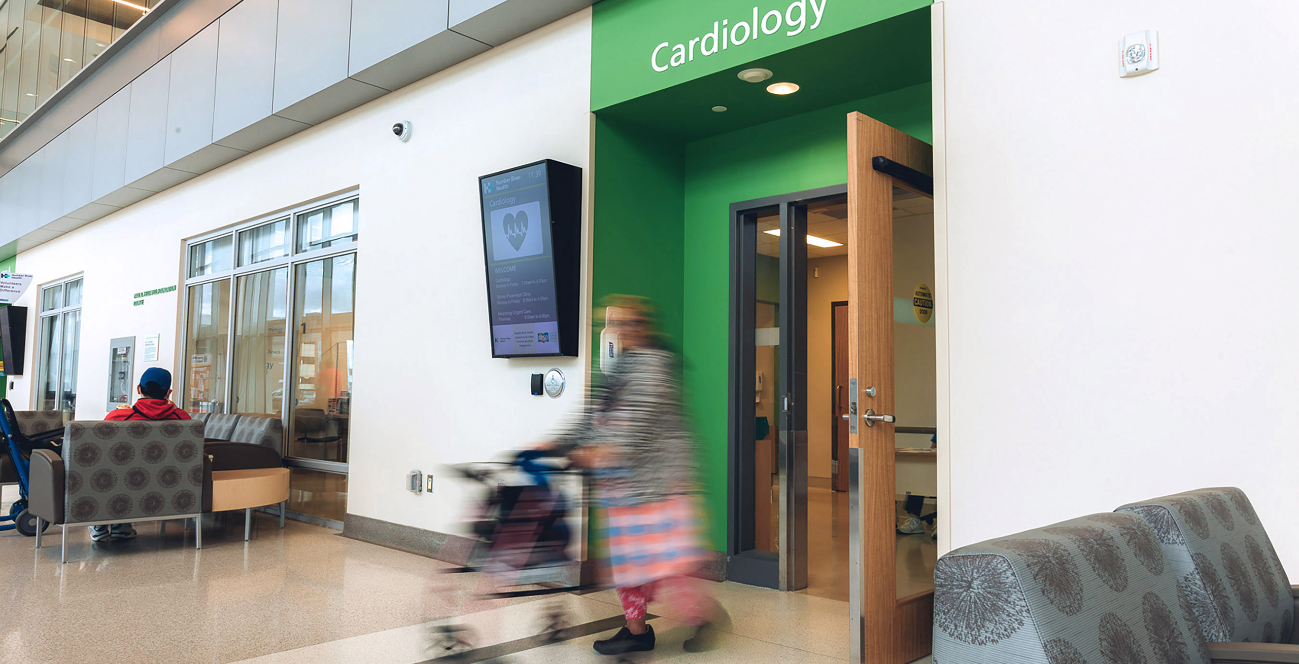 Motion blurred image of an elderly woman exiting the Cardiology wing.