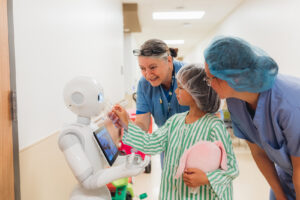 Alex, Isabelle and Carolyn with Pepper, Child Life Program